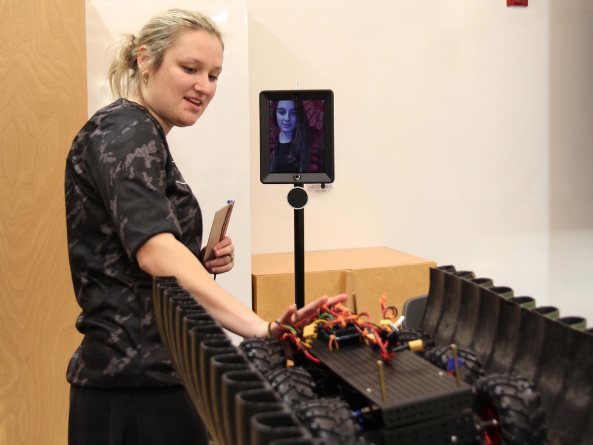 Cara Fiala, Philadelphia regional engineering student, explains a project to a student at the University of Maine.