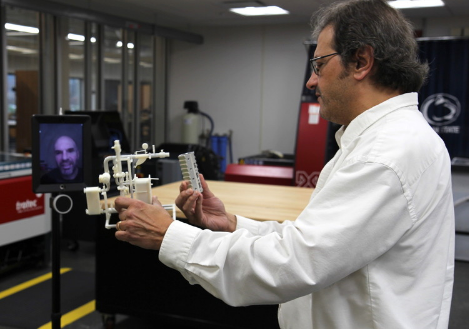 Robert Avanzato, Penn State Abington associate professor of engineering, uses a telepresence robot to connect with students at the University of Maine.